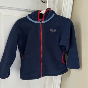 Unisex Patagonia fleece. navy blue with red piping.